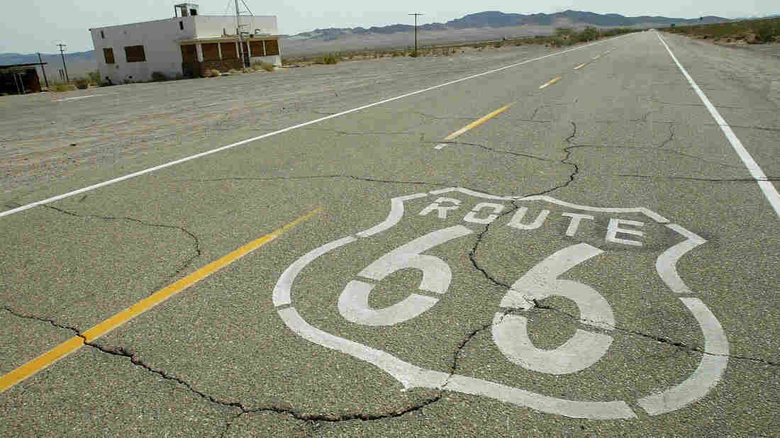 Route 66 is stenciled on the old road through an abandoned town in California's Mojave desert 14 July 2003.