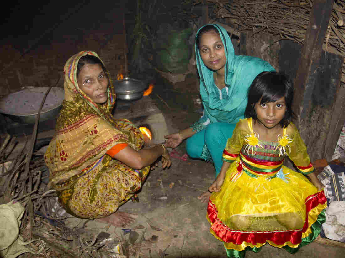 Minu's mother, Noor Jahan Begum, Minu, and Minu's daughter, Sumaiya, in the kitchen of Minu's parent's home.