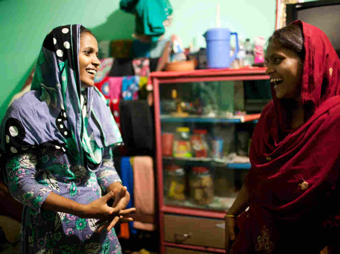 Shumi, left, and Minu, right, inside the small room they share with Minu's husband.