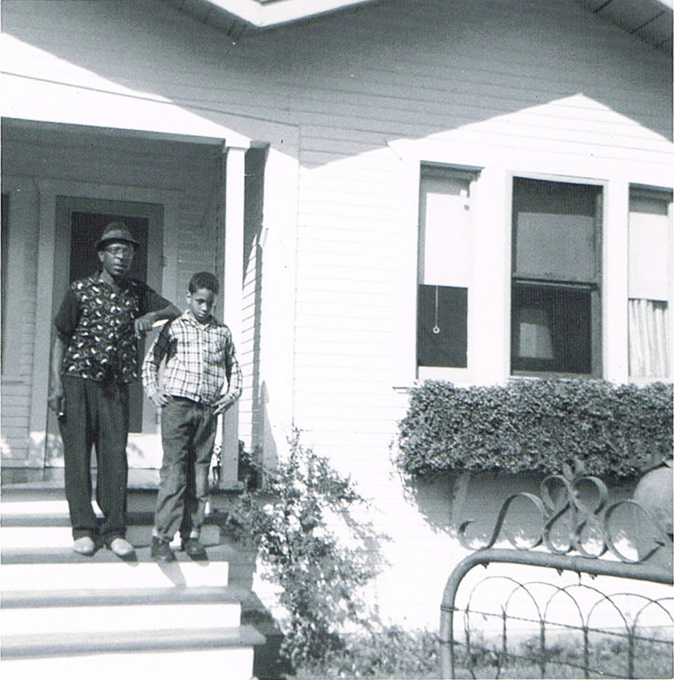 Author Walter Mosley in front of his childhood home in the LA neighborhood of Watts. He's standing with his father. (Courtesy of Walter Mosley)