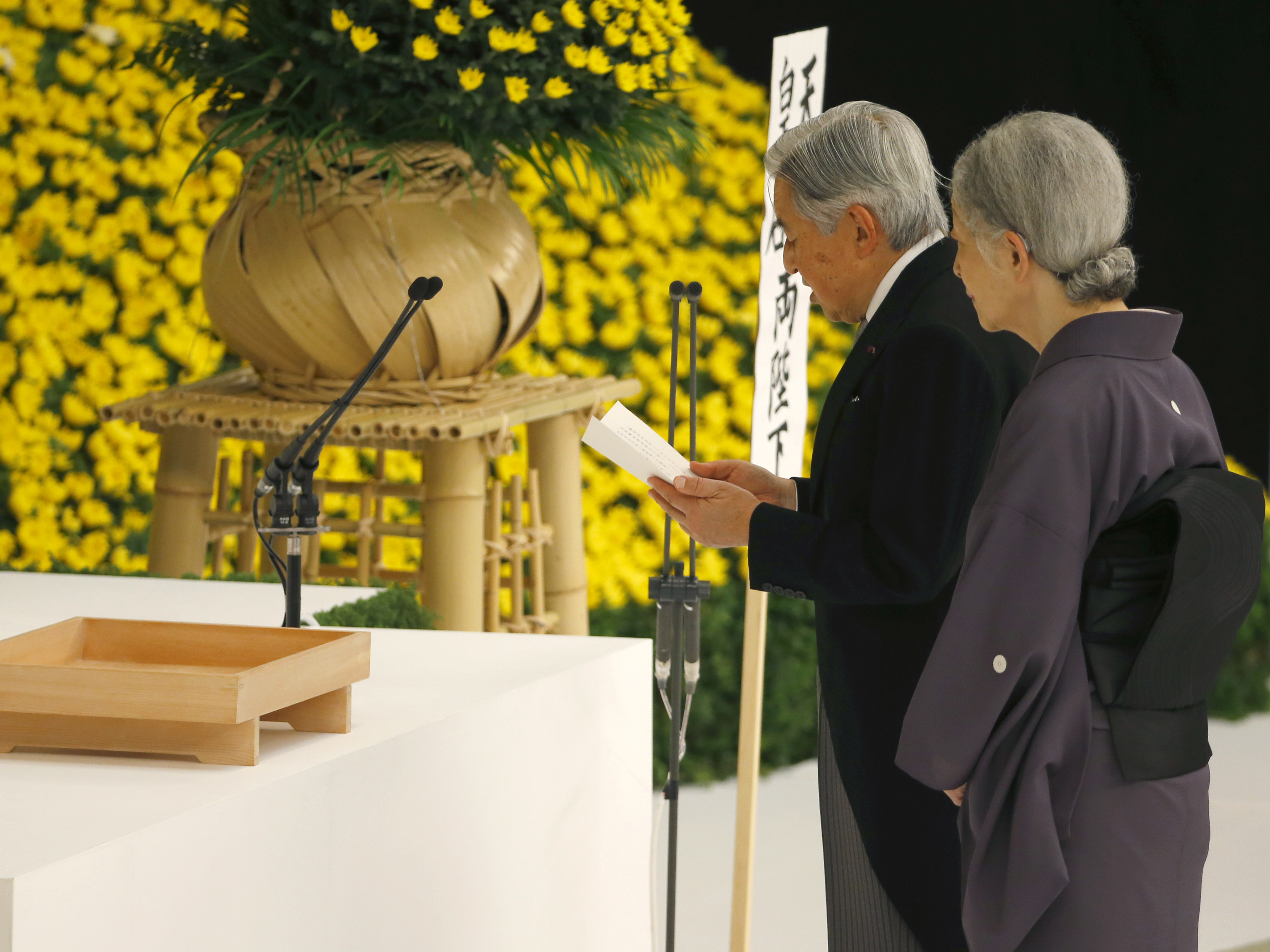 Japan's Emperor Akihito delivers his remarks with Empress Michiko during a memorial service at Nippon Budokan martial arts hall in Tokyo, on Saturday. His expression of "deep remorse" for Japan's wartime past is seen as an unprecedented apology.