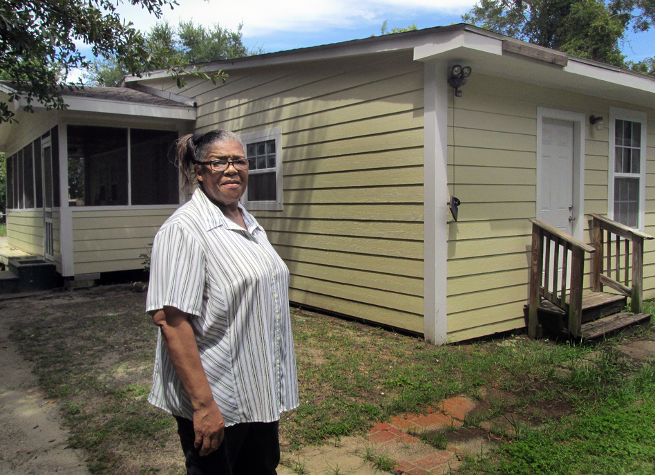 Mississippi resident Ethel Curry stands in front of her East Biloxi home, which was rebuilt with the help of volunteers after Hurricane Katrina. (Evelina Burnett/MPB)