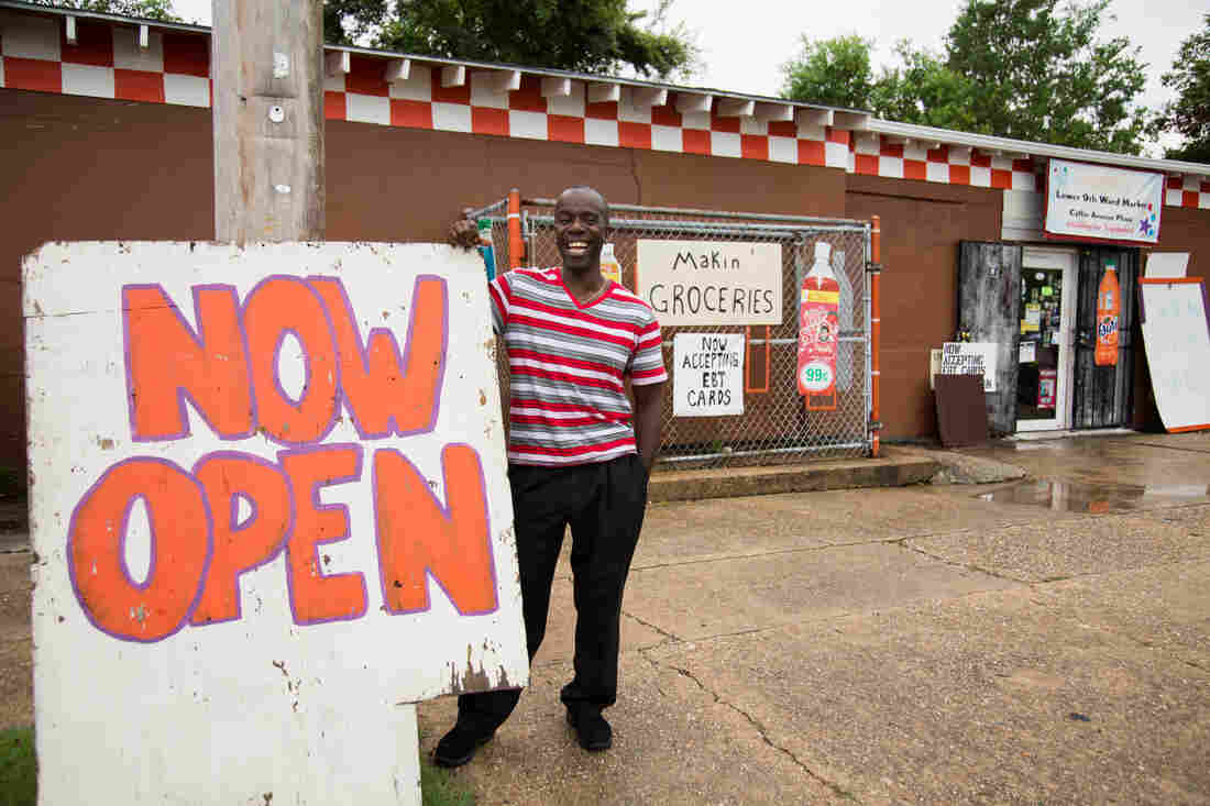 Cotlon in front of his grocery store.