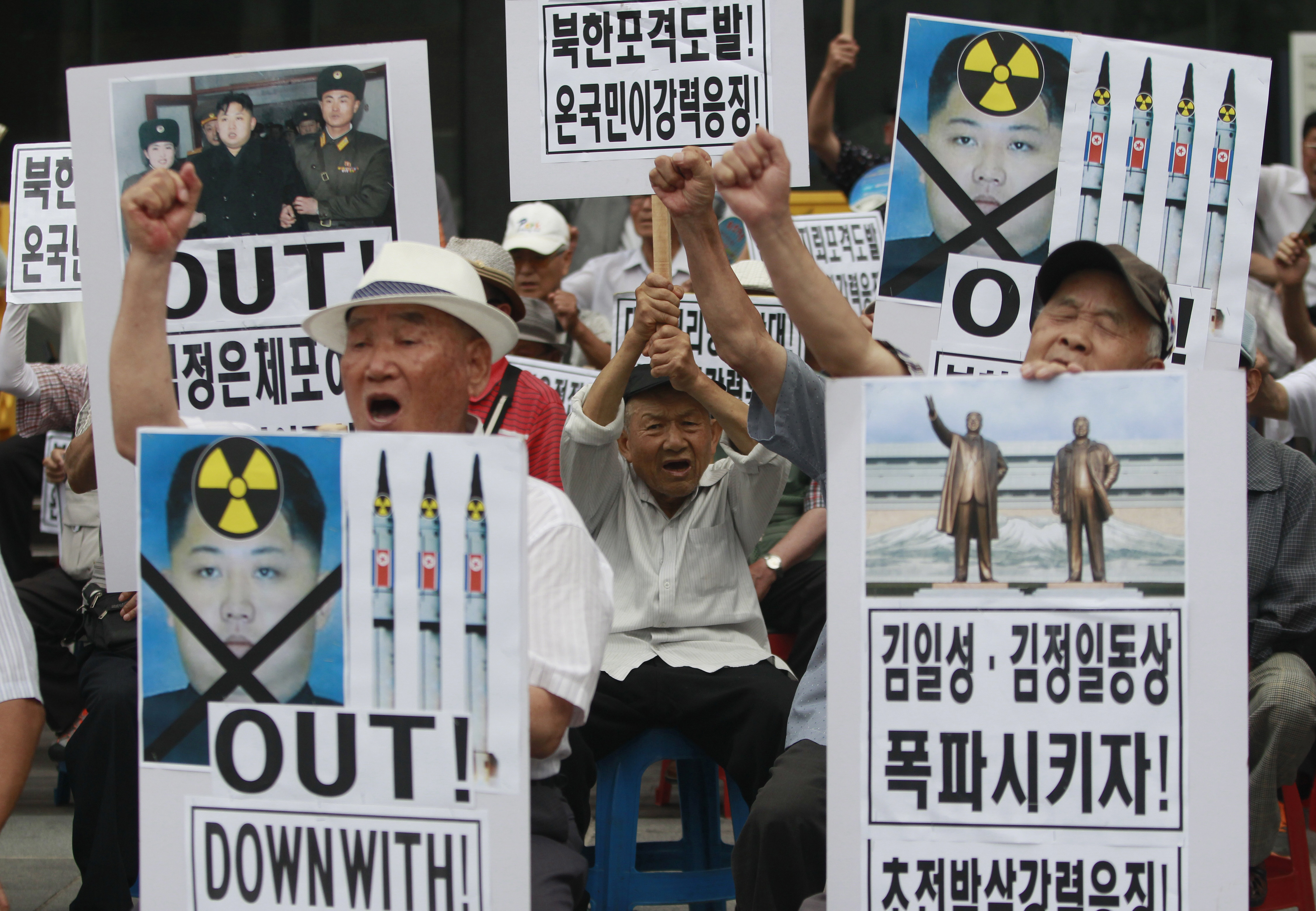 South Korean protesters with defaced portraits of North Korean leader Kim Jong Un shout slogans during an anti-North Korean rally in Seoul on Friday.