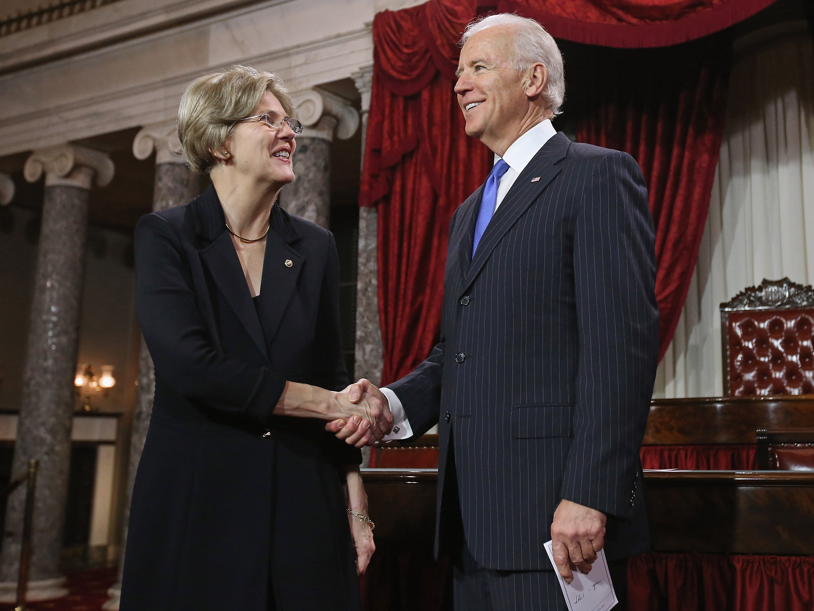 Massachusetts Democratic Sen. Elizabeth Warren and Vice President Biden at a ceremonial re-enactment of Warren's swearing-in on Jan. 3, 2013, in the Old Senate Chamber of the Capitol.