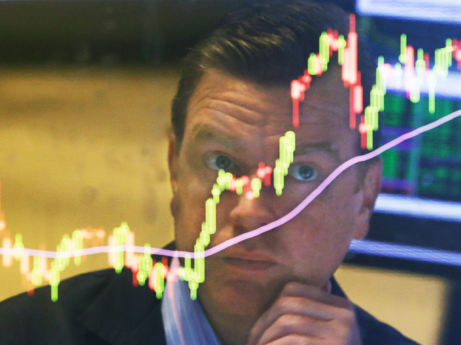 Specialist Michael O'Mara on the floor of the New York Stock Exchange on Tuesday. Stocks closed down 200 points after starting the day with a rally. But there's more going on in the economy than the drama on Wall Street. (Richard Drew/AP)