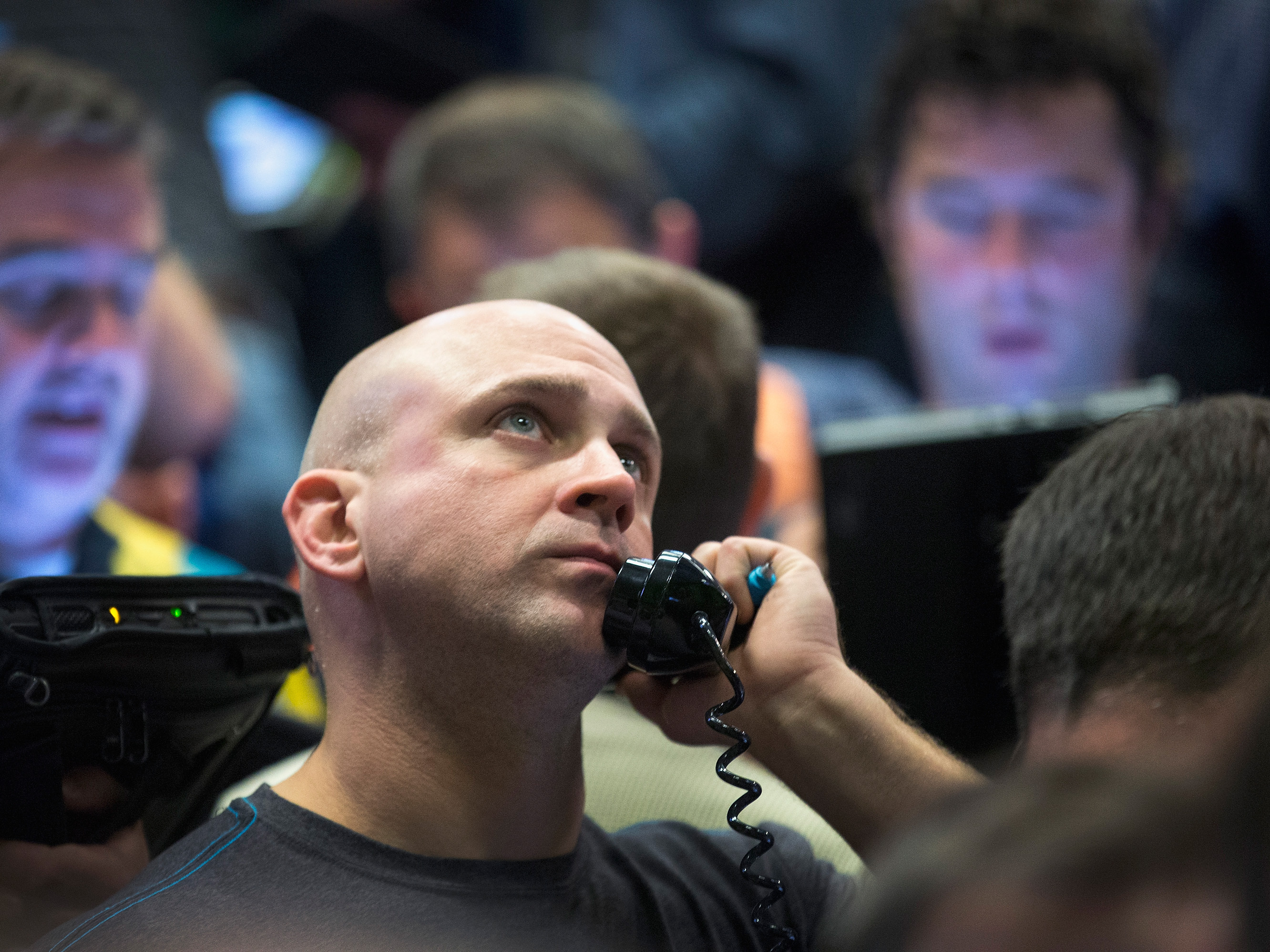 A trader fills orders Monday in the Standard & Poor's 500 stock index options pit at the Chicago Board Options Exchange. Watching market numbers plummet can make investors queasy, but analysts say keeping a level head through volatility is the best course.