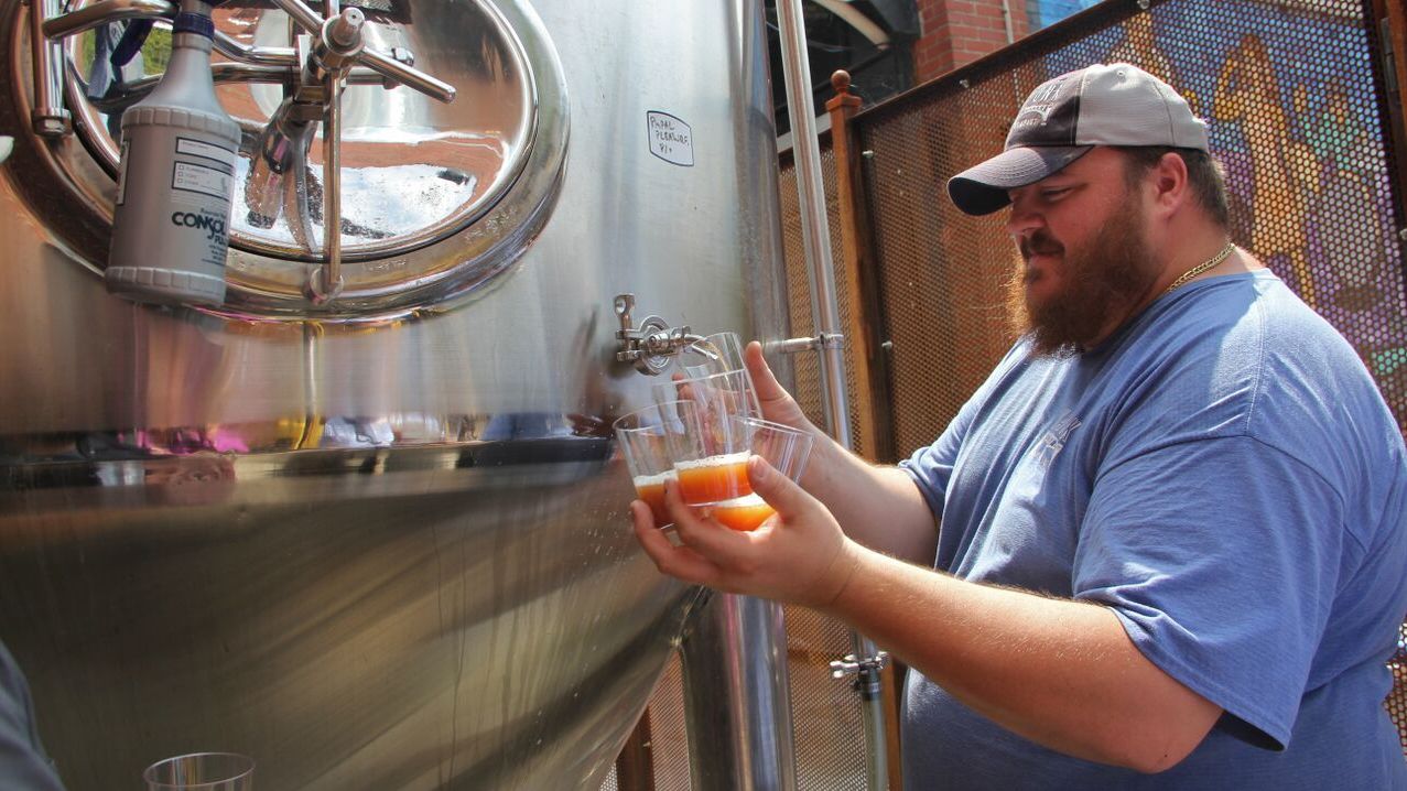 Evan Fritz, head brewer at Manayunk Brewing Co., draws off some samples of Papal Pleasure, a beer concocted to mark Pope Francis' visit to Philadelphia. It's brewed with water blessed by a local priest.