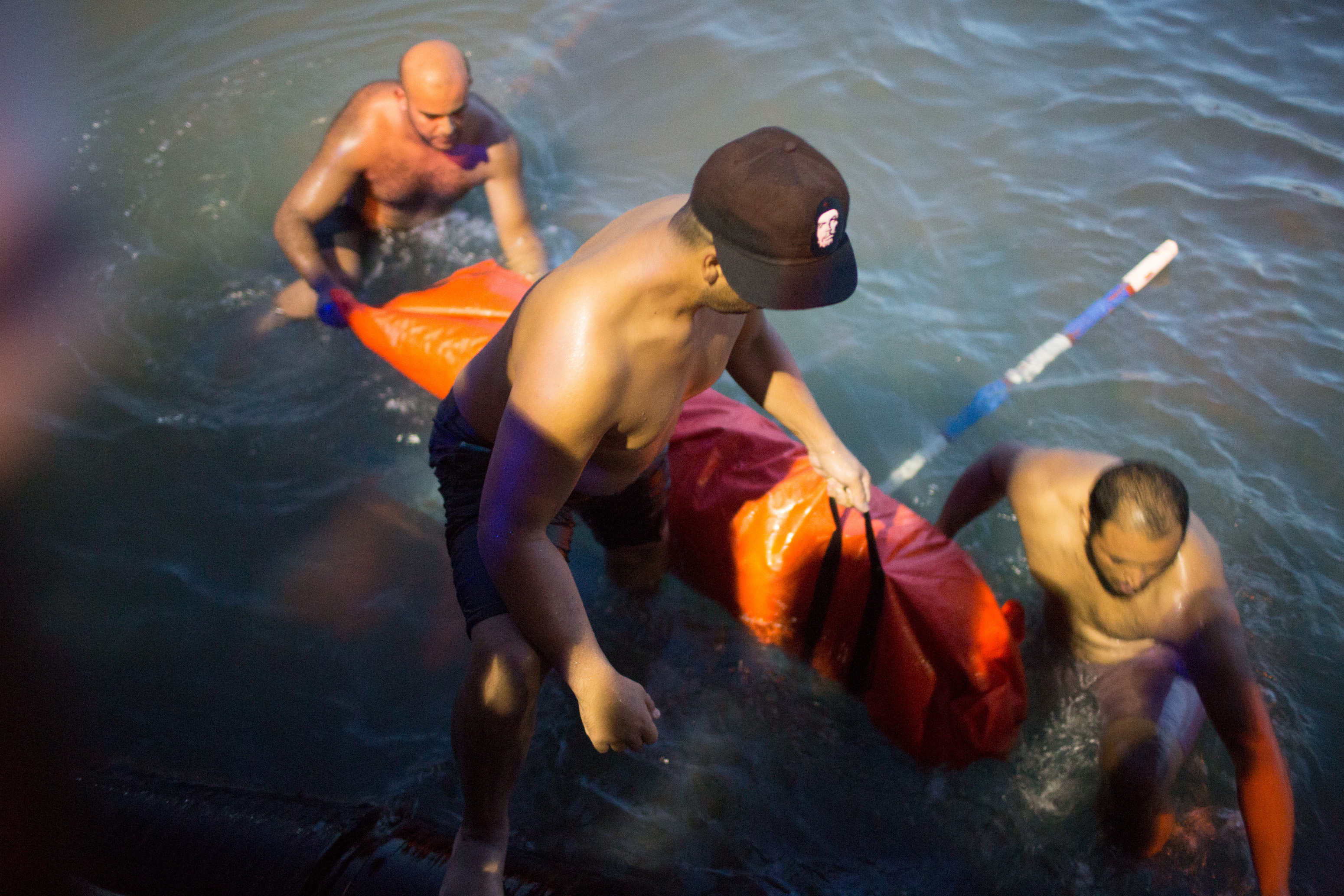 Rescuers remove the body of a migrant after their boat sank off the coast of in Zuwara, Libya, on Thursday.