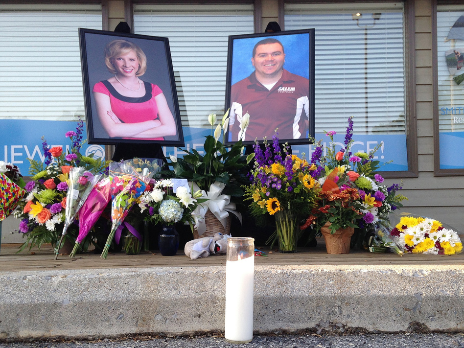 A candle burns in front of a memorial for two slain journalists, Alison Parker and Adam Ward. (Jonathan Drew/AP)
