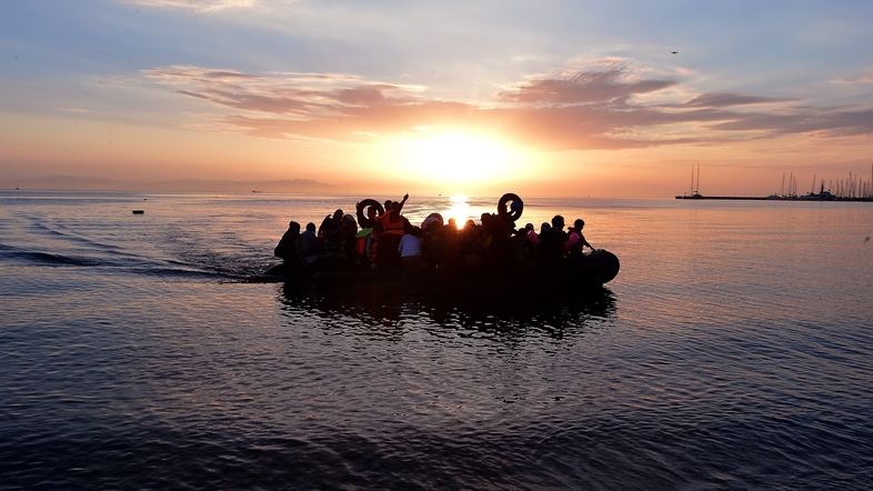Syrian migrants in an overcrowded dinghy from Turkey arrive on the Greek island of Kos on Aug. 29. (Louisa Gouliamaki/AFP/Getty Images)