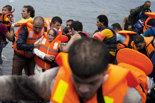 Syrian refugees arrive on the Greek island of Lesbos after crossing the Aegean Sea from Turkey on Tuesday.