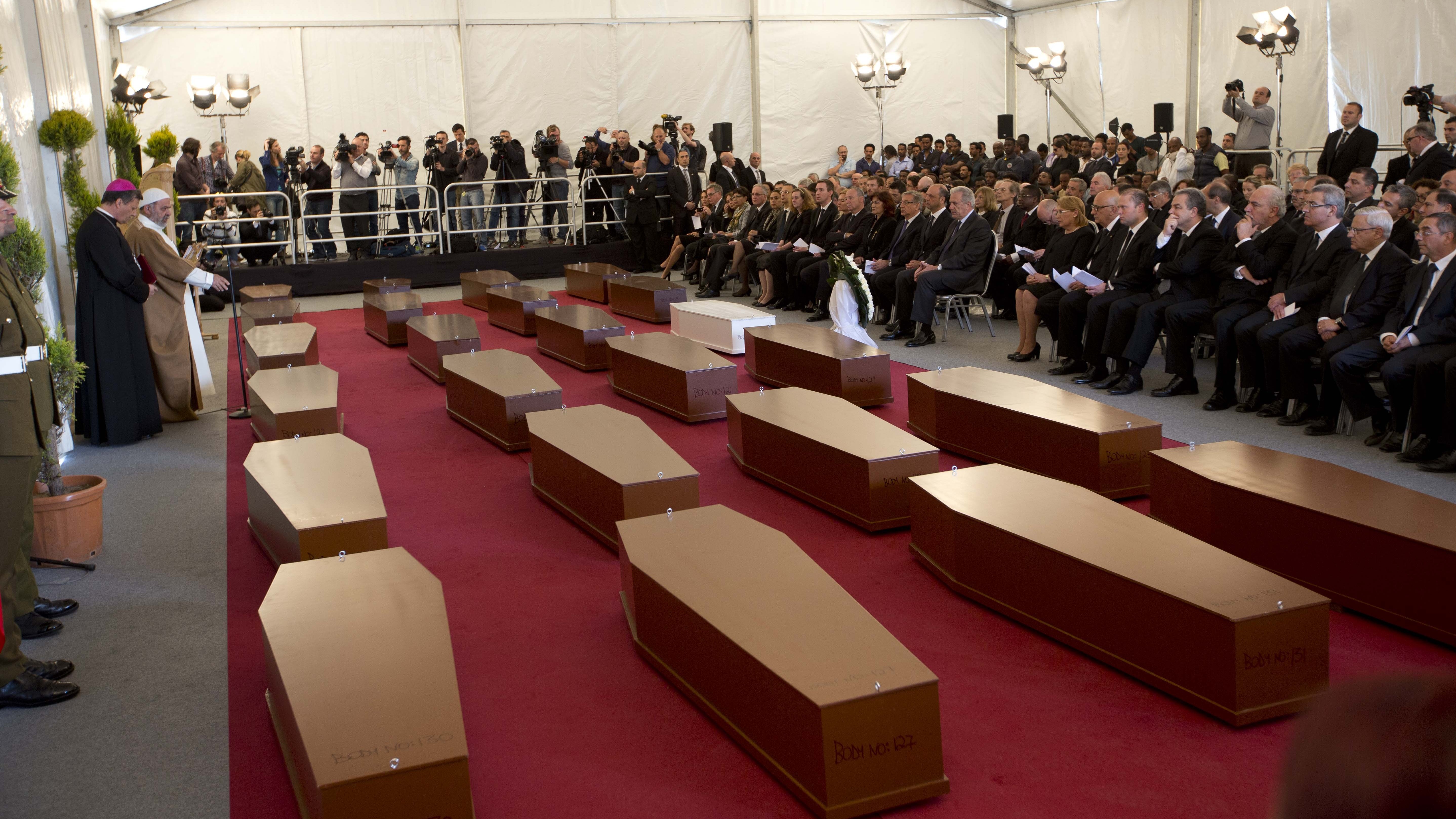 A funeral service for 24 migrants who drowned while trying to reach the southern coasts of Italy, in April. The migrants died as a smuggler's boat crammed with hundreds of people overturned off the coast of Libya.