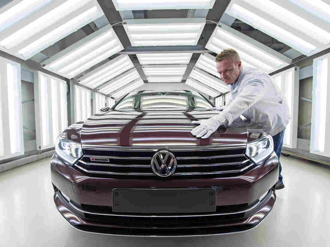 A worker checks a Passat Variant during a press tour at the plant of the German manufacturer Volkswagen Sachsen in Zwickau, Germany.