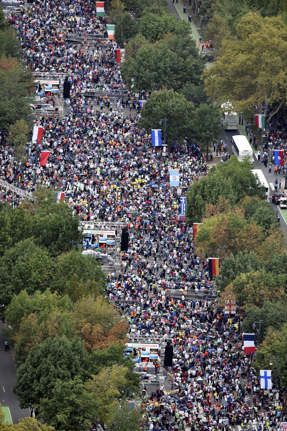 People gather on the Benjamin Franklin Parkway before the Papal Mass on Sunday in Philadelphia. (Michael Perez/AP)