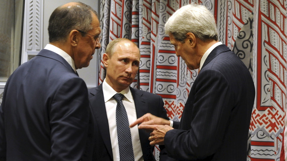 Russia has ramped up its role in Syria's civil war. Here, President Vladimir Putin (center) speaks with Secretary of State John Kerry (right) and Foreign Minister Sergei Lavrov at the U.N. General Assembly on Monday. (RIA NOVOSTI/Reuters /Landov)