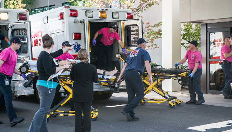 A patient is wheeled into the emergency room at Mercy Medical Center in Roseburg, Ore., following a deadly shooting at Umpqua Community College in Roseburg on Thursday. (Aaron Yost/Roseburg News-Review via AP)