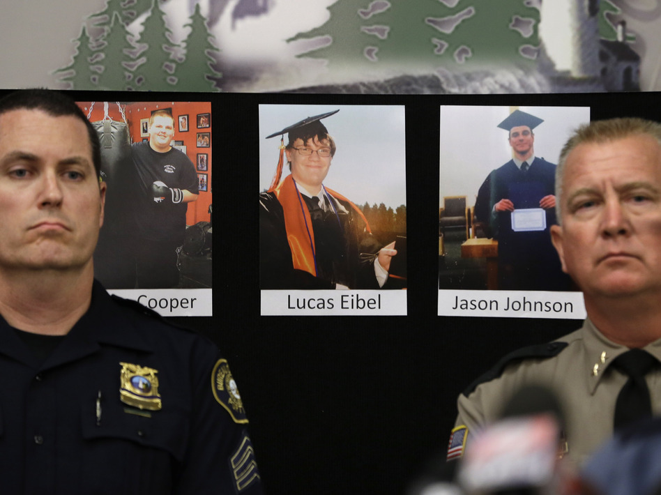 Photos of victims of the mass shooting at Umpqua Community College in Roseburg, Ore., are displayed behind Portland Police Sgt. Peter Simpson (left) and Douglas County Sheriff John Hanlin. (Rich Pedroncelli/AP)