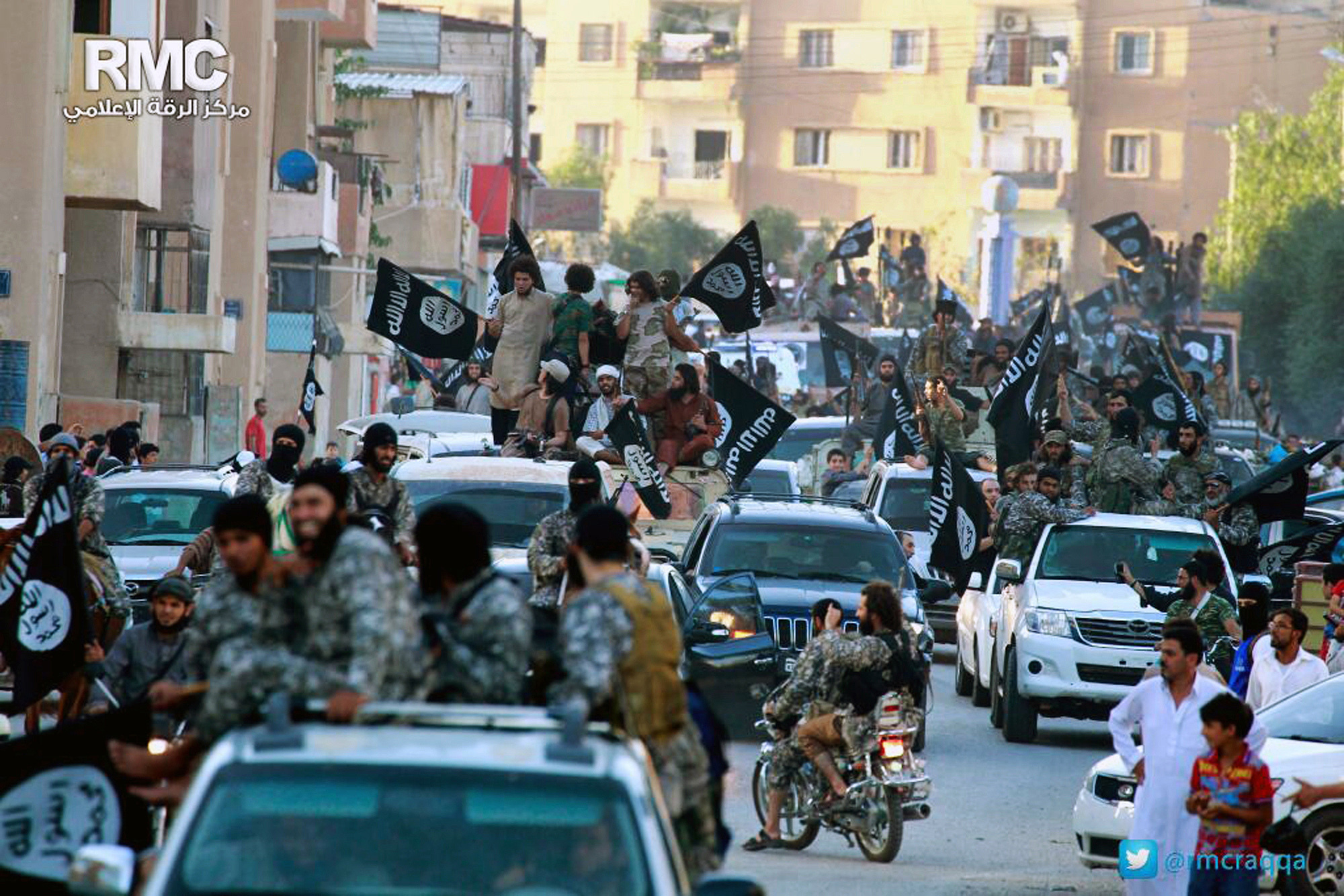 Fighters from the Islamic State group parade in Raqqa, northern Syria. The U.S. is considering arming Arab and Kurdish fighters who are poised to attack the Islamic State stronghold.