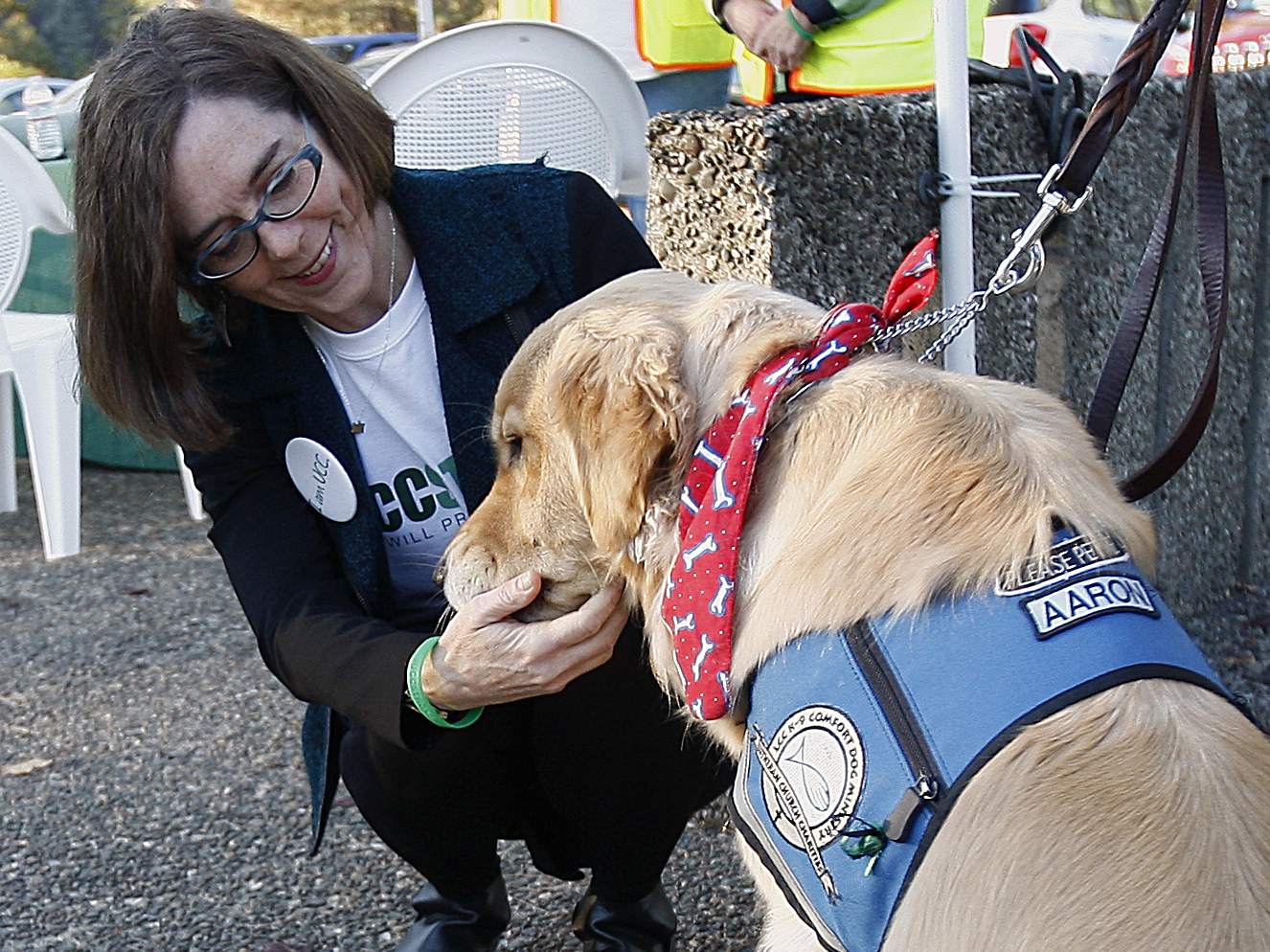Oregon Gov. Kate Brown greets a therapy dog Monday,  during a tour of Umpqua Community College in Roseburg, Ore. Monday was the first day back to campus for students since the mass shooting on Oct. 1.