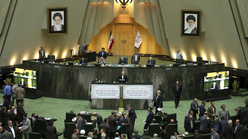 Head of Iran's Atomic Energy Organization Ali Akbar Salehi, center, speaks in an open session of parliament while discussing the bill on Iran's nuclear deal with world powers, in Tehran, Iran, Oct. 11, 2015. Starting Sunday, the approved nuclear deal begins being adopted and implemented. (Ebrahim Noroozi/AP)