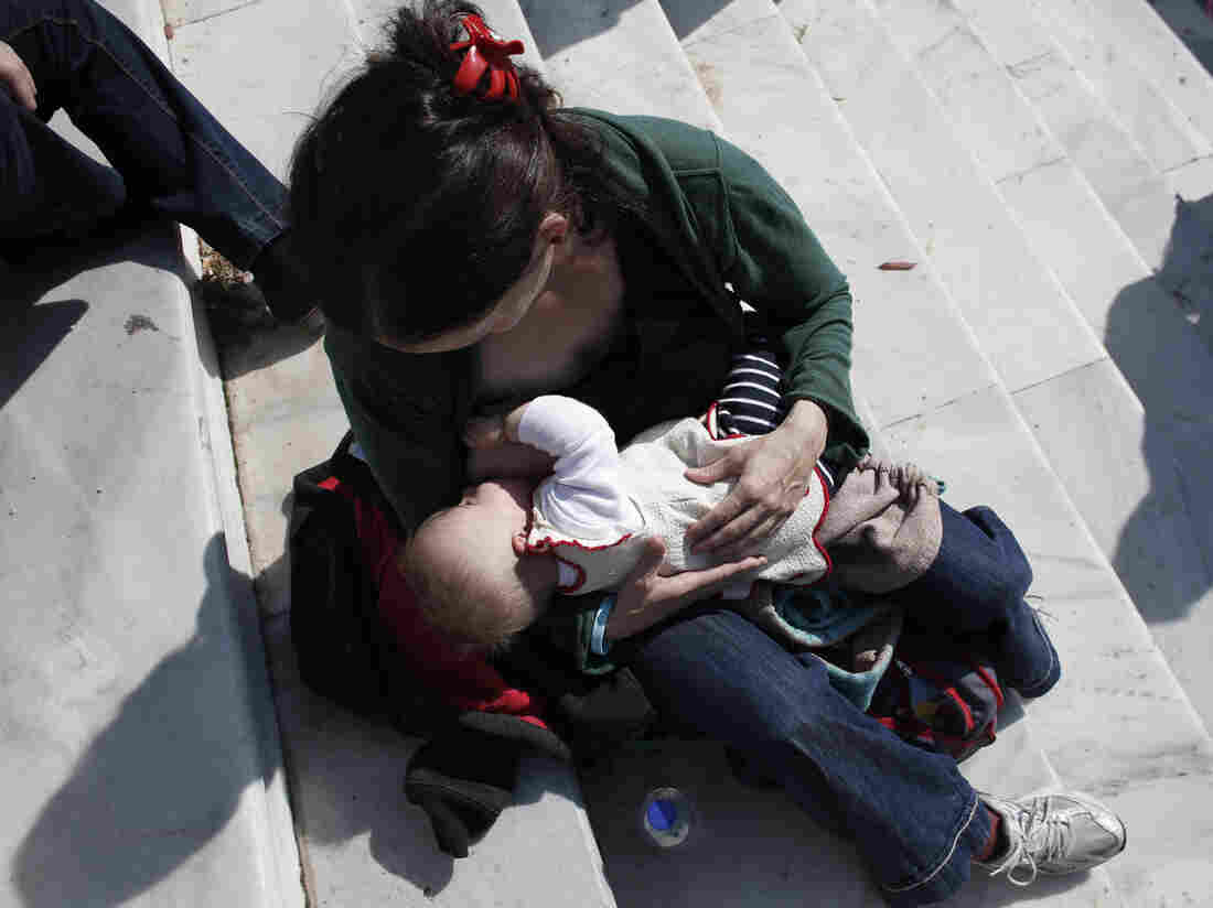 A mother breast-feeds her baby during an event in central Athens in November.