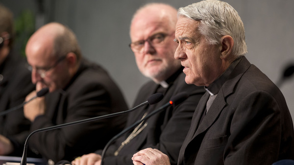 Vatican spokesman Rev. Federico Lombardi (right) is denying claims in Italian newspapers that Pope Francis has a benign brain tumor. The rumors are part of an attempt to undermine the pope, the Vatican says.