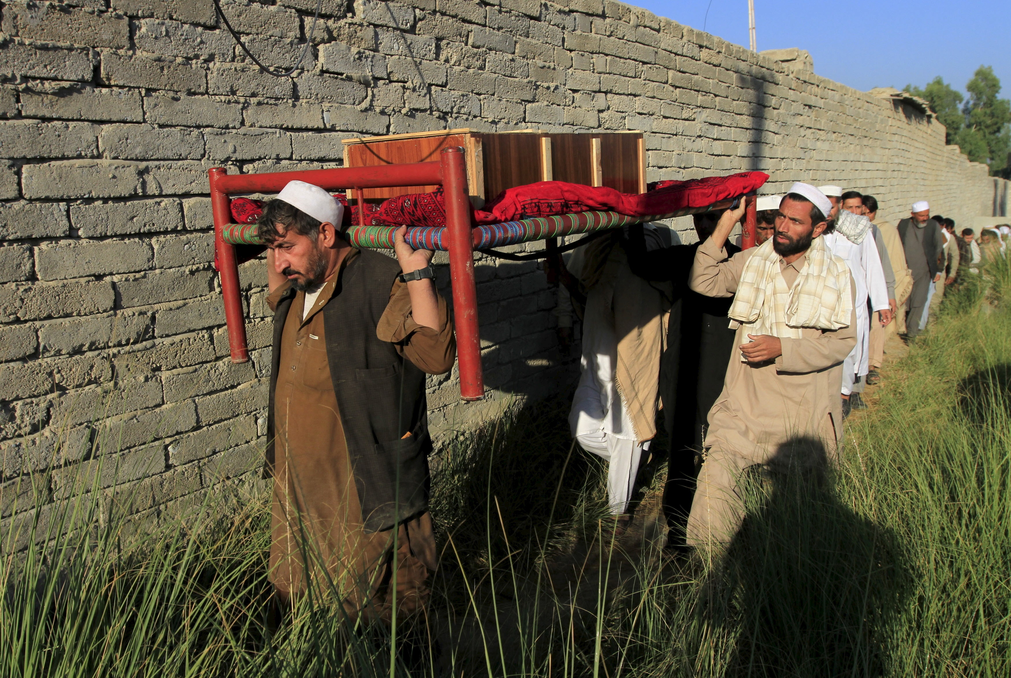 Afghan men carry a coffin of an earthquake victim for burial in the Behsud district of Nangarhar province, Afghanistan, on Tuesday.