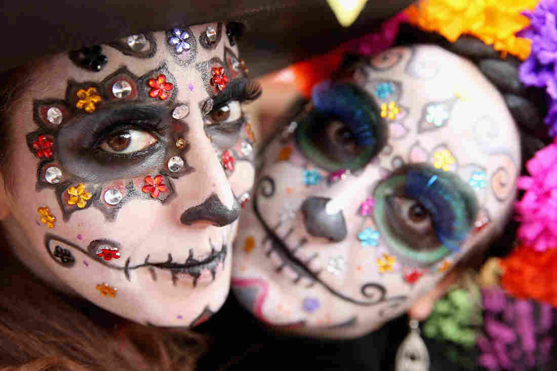 Girls in face paint celebrate Day Of The Dead.