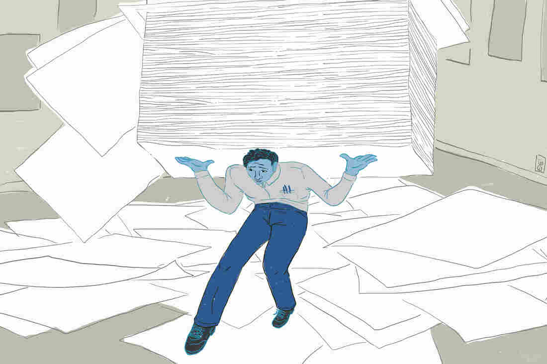 Man carrying huge stack of papers and papers strewn about