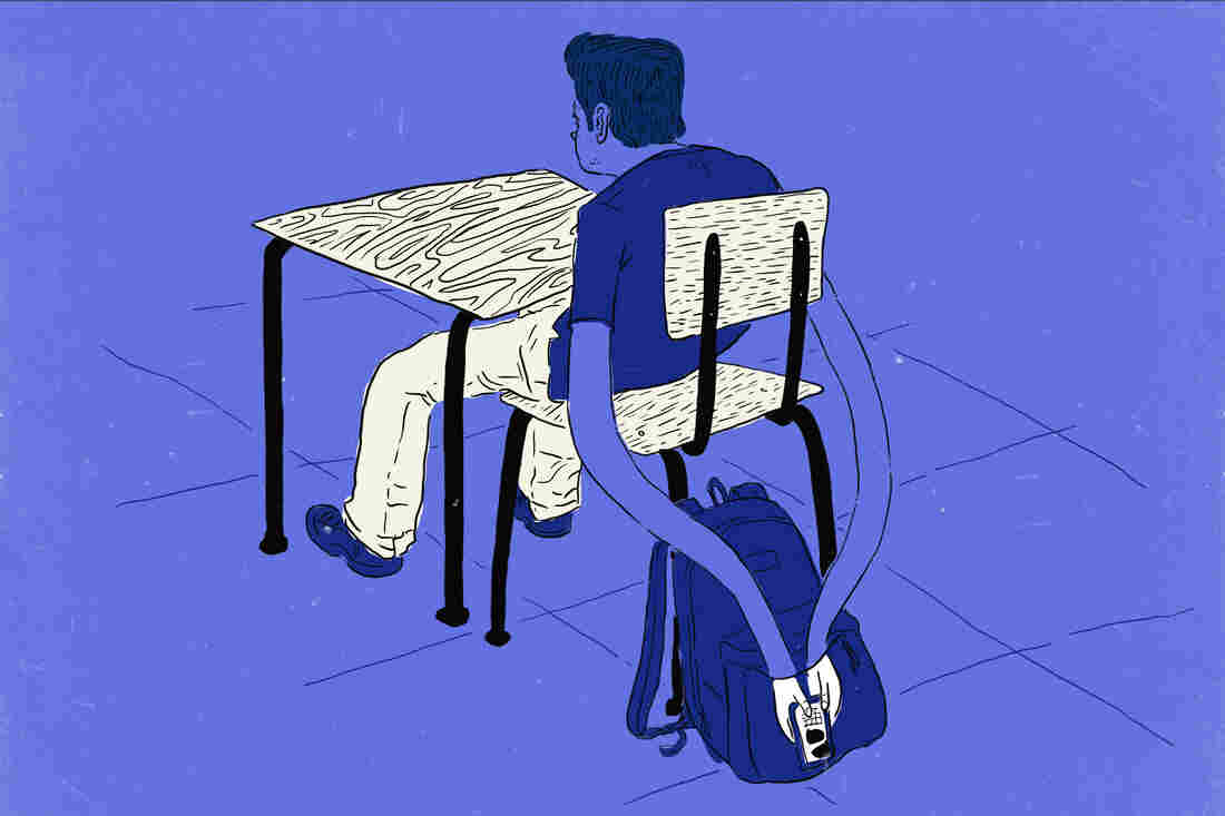 Kid in class reaching into book bag to text on cellphone.