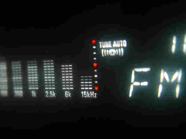 Auto tuner display shows FM signal equalizer.