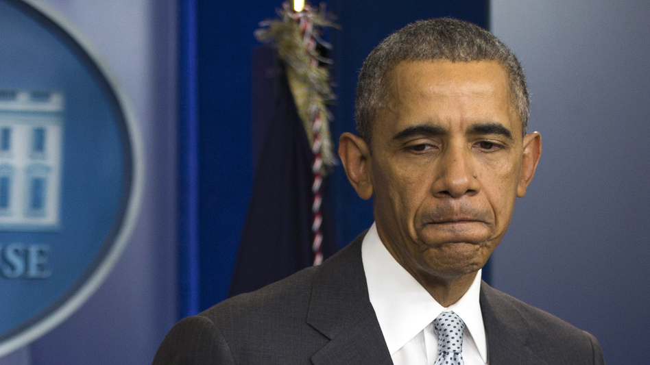 President Obama pauses as he speaks about attacks in Paris from the briefing room of the White House on Friday. (Evan Vucci/AP)