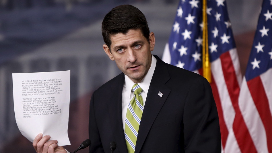 Speaker of the House Paul Ryan holds up statements from the FBI director and the secretary of Homeland Security about the risk involved in admitting refugees from Syria, during a news conference Wednesday about the House bill calling for a stricter vetting process for refugees from Syria and Iraq. (Gary Cameron/Reuters/Landov)