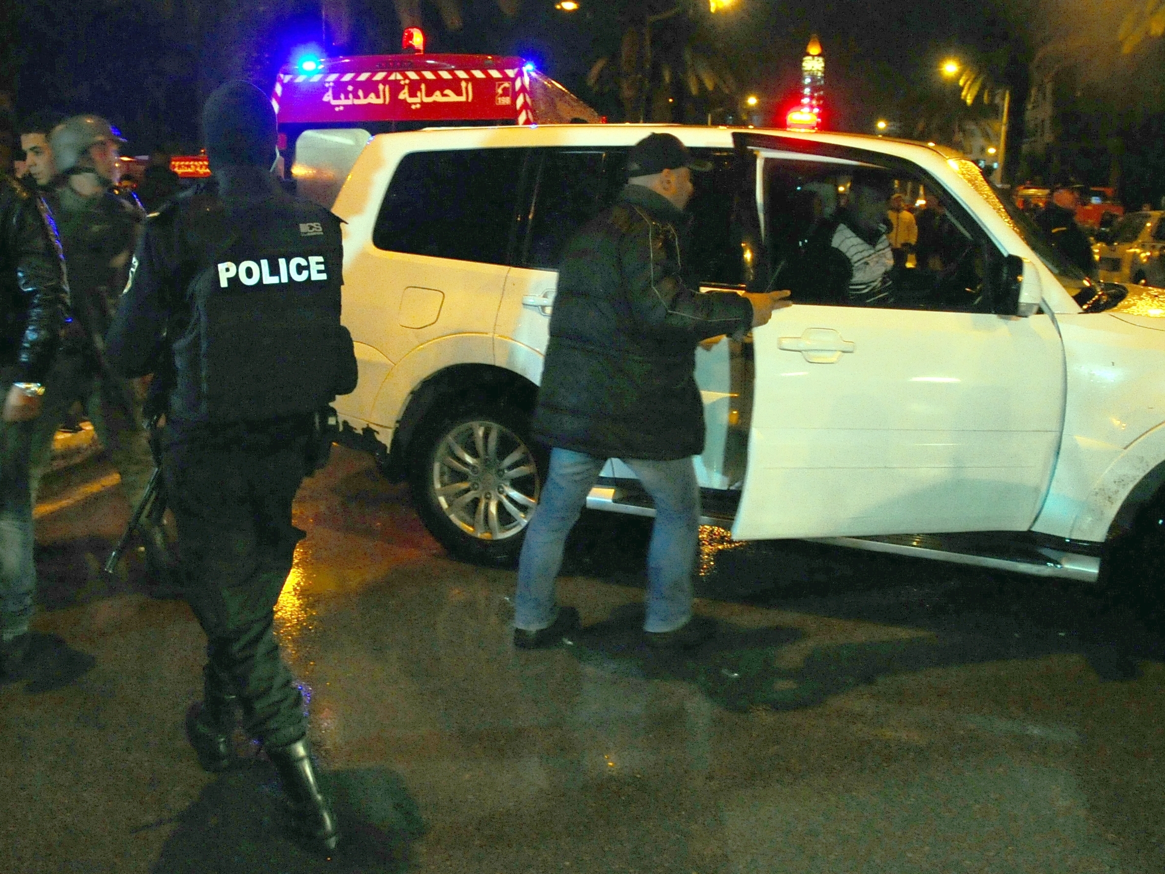 Police officers take positions as they arrive at scene of a bus explosion in the center of Tunis, the capital city of Tunisia, Tuesday.