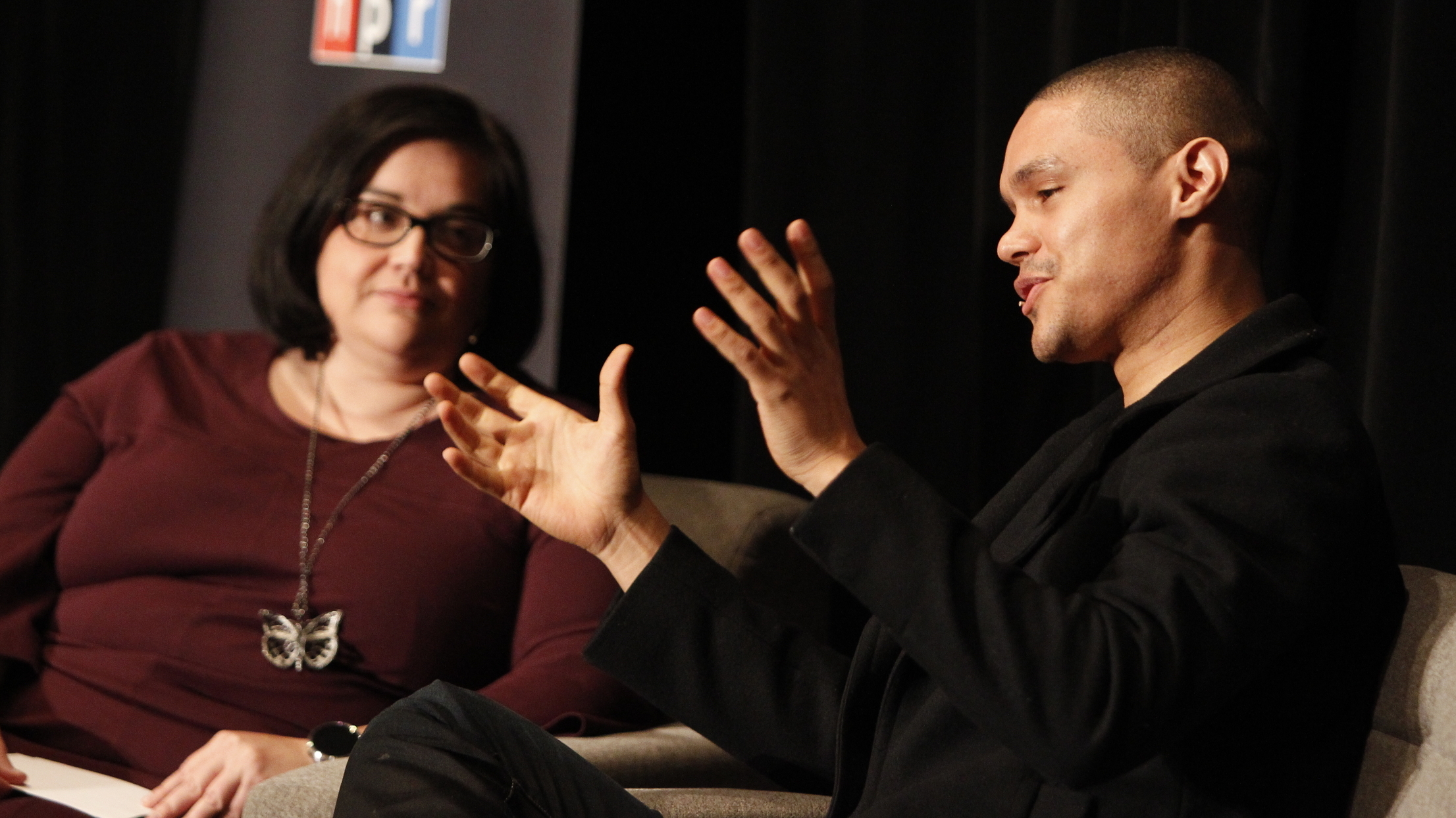 Linda Holmes and Trevor Noah talk during NPR's Weekend In Washington event on October 31. (AP Images for NPR)