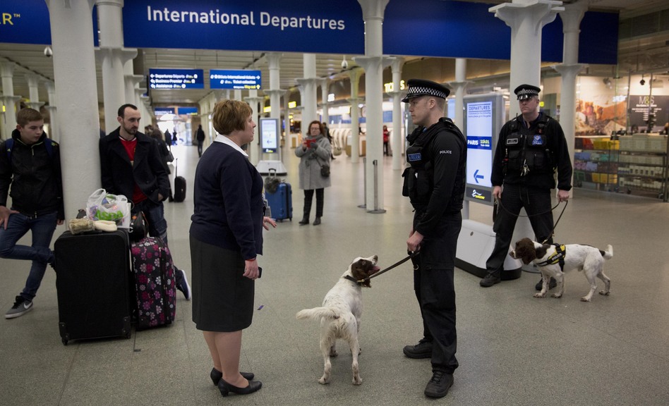 British police dog handlers patrol a train station in London in January. (Matt Dunham/AP)