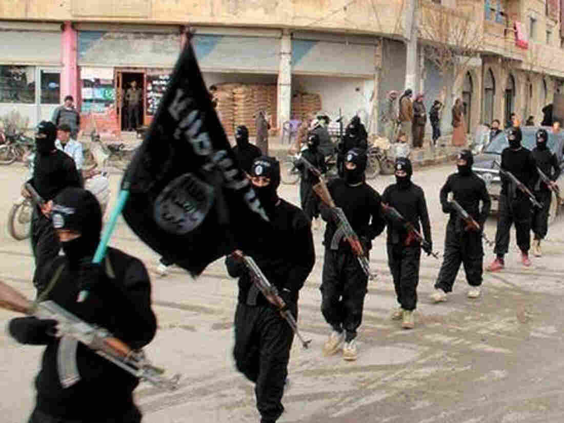 FILE - This undated file image posted on a militant website on Jan. 14, 2014, shows fighters from the Islamic State group marching in Raqqa, Syria. T (AP Photo/Militant Website, File)