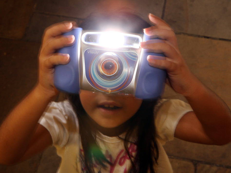 Charlize, 8, plays with the Kidizoom Multimedia Digital Camera made by VTech in 2009. A recent data breach hacking sensitive information, including kid's photos, is prompting parents to look twice at their children's technology usage. (Oli Scarff/Getty Images)