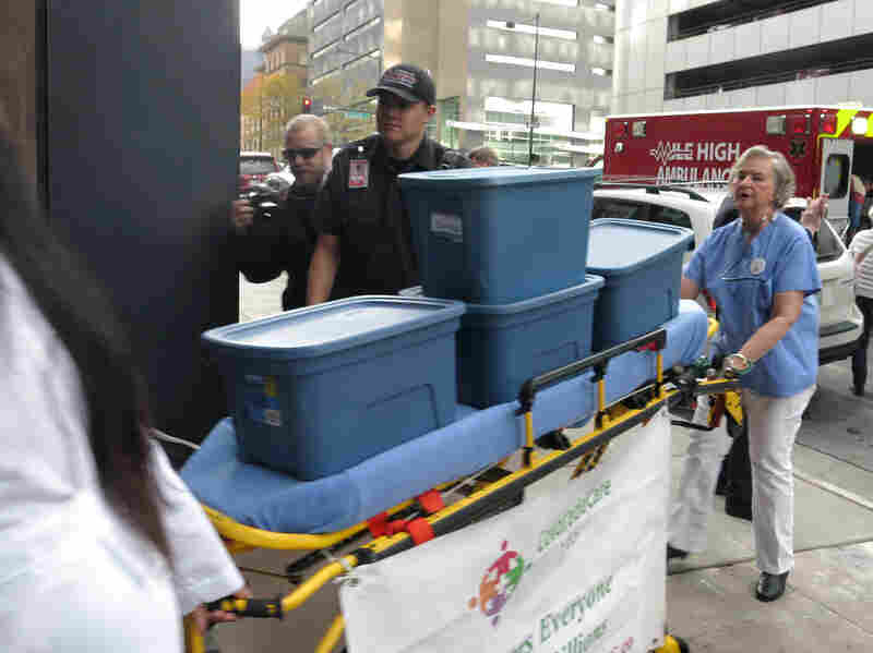 Supporters of single-payer health care delivered signatures supporting their ballot measure on a stretcher to Colorado's secretary of state.