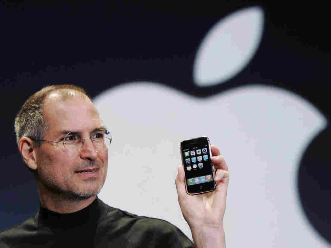 Apple CEO Steve Jobs holds up an Apple iPhone at the Macworld Conference in San Francisco on Jan. 9, 2007.