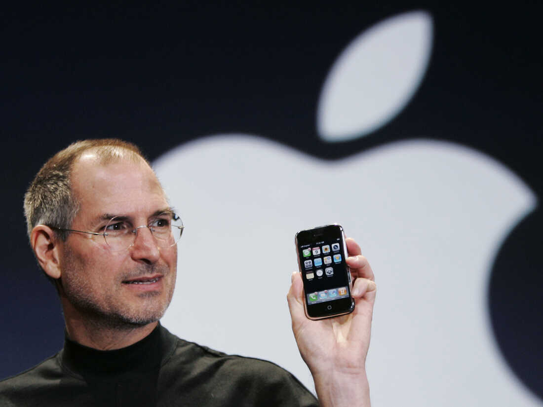 Apple CEO Steve Jobs holds up an Apple iPhone at the Macworld Conference in San Francisco on Jan. 9, 2007.