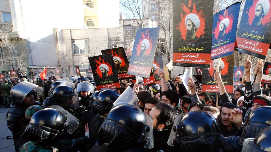 Iranian security forces stand guard as protesters demonstrate outside the Saudi Arabian Embassy in Tehran. The crowd was decrying the execution of Nimr al-Nimr, a prominent Saudi Shiite cleric, by Saudi authorities — an execution that has heightened sectarian tensions in the region. (Anadolu Agency/Getty Images)