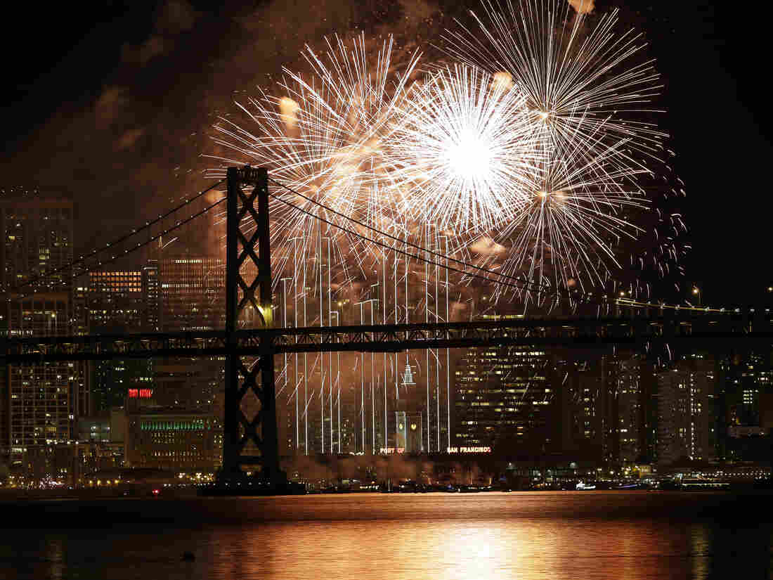 Fireworks light up the sky over the San Francisco-Oakland Bay Bridge and the city skyline as part of New Year's Eve celebrations.