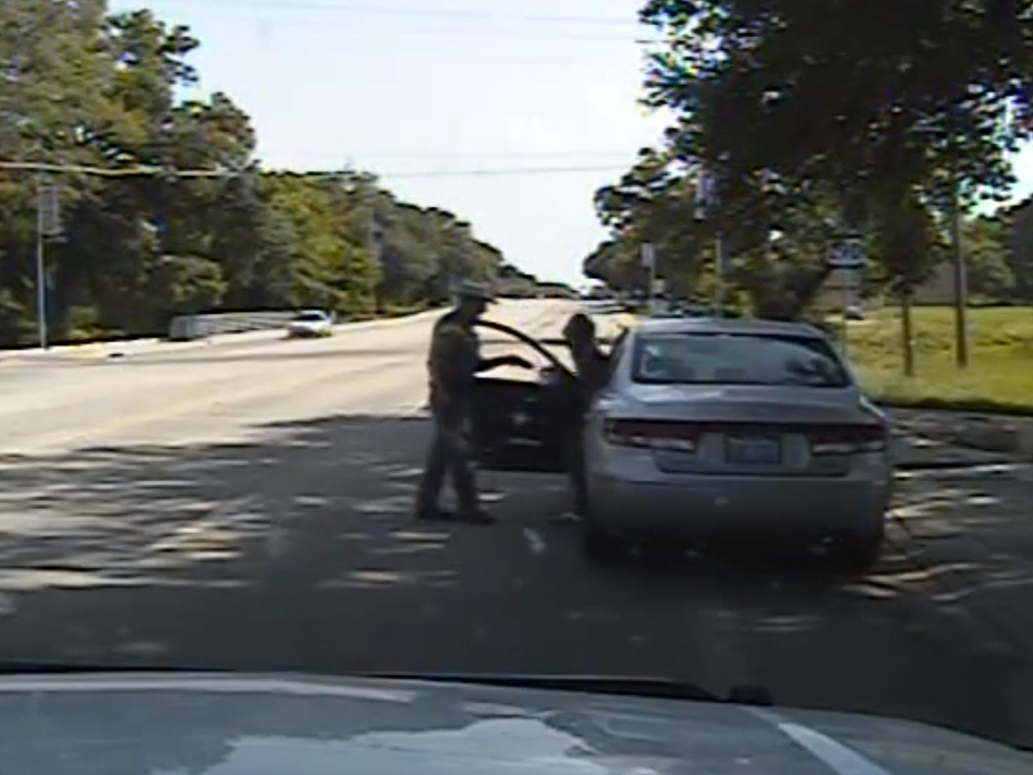 In this frame from the dashcam video, Texas State Trooper Brian Encinia confronts Sandra Bland after a minor traffic infraction. She was later arrested and was found hanged in her jail cell days later. (Uncredited/AP)