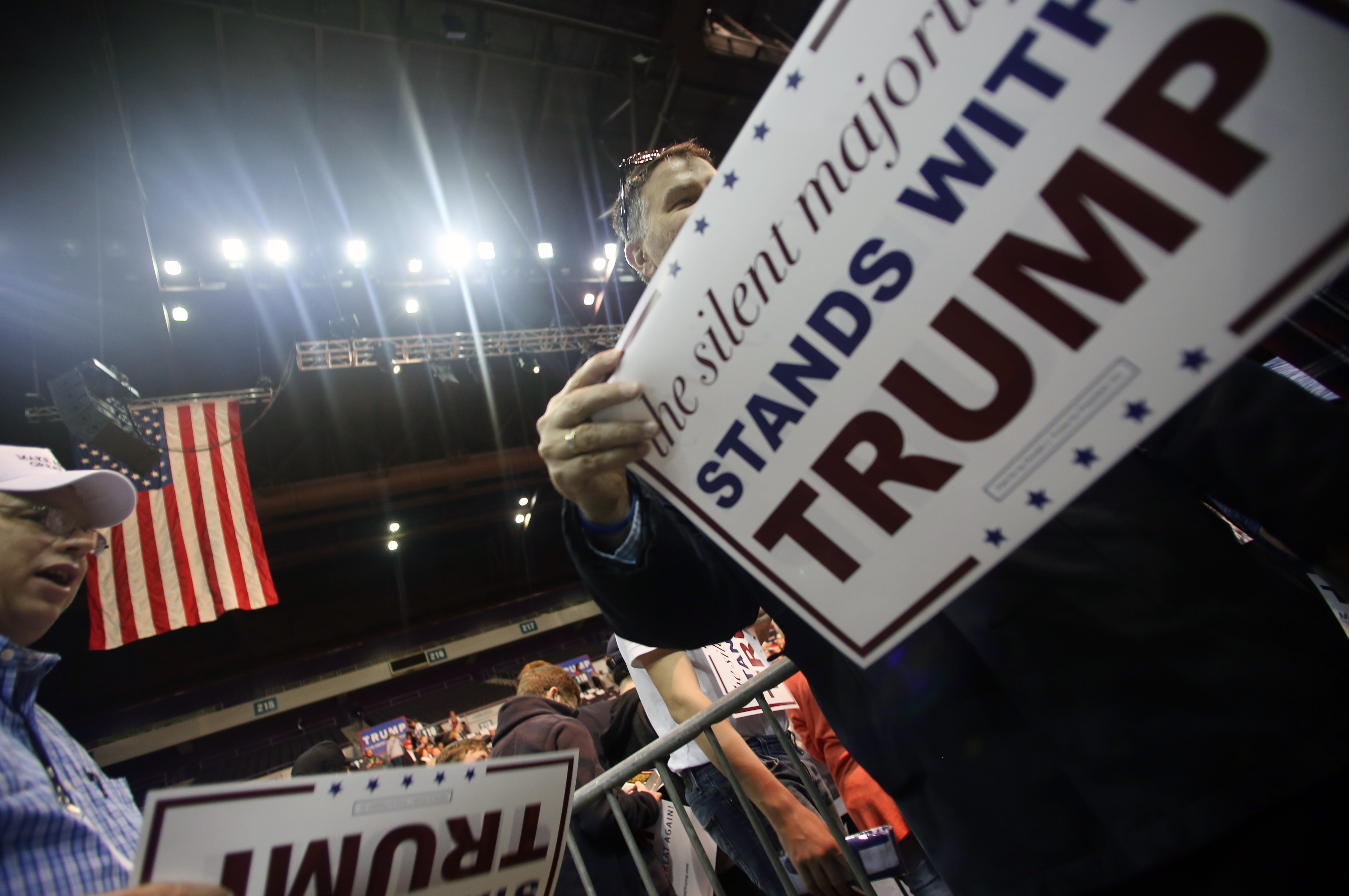 Supporters hand out placards during Republican presidential candidate Donald Trump's campaign rally in Pensacola, Fla.