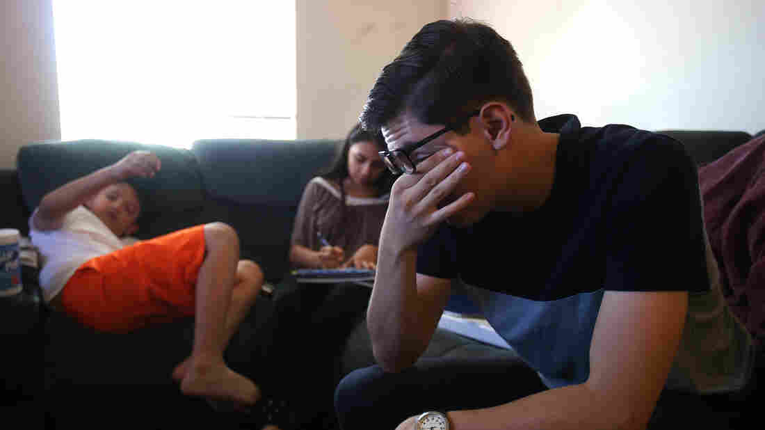 Bill de la Rosa packs and says goodbye to family before catching his flight back to college in Maine. He tells his younger siblings to do good in school and promises to check in on them a couple of times a week.. Photo taken Sunday, Aug. 30, 2015.