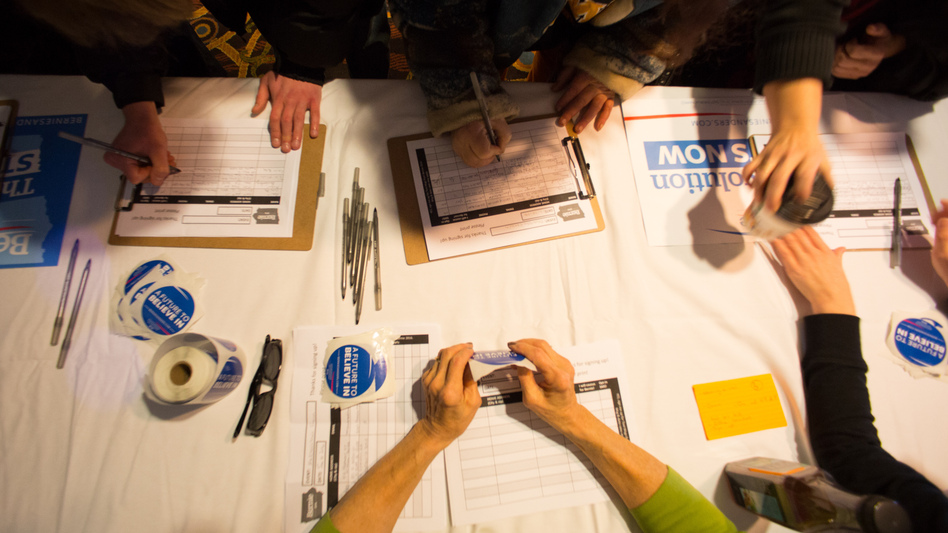 Guests sign in for a Bernie Sanders campaign event in Marshalltown, Iowa, in January. One big question is whether Sanders and outsider Donald Trump, who have been attracting large crowds, can get their supporters to caucus. (Getty Images)