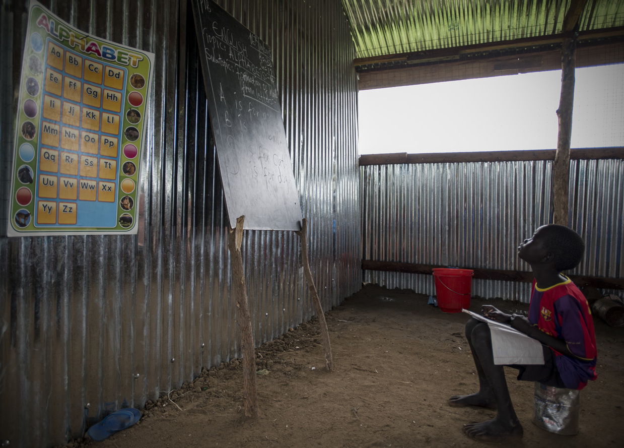 A child in South Sudan studies in a school. Fewer than half of the school-age kids are in school in South Sudan, one of the world's poorest countries, which has also been plagued by war. (UNICEF South Sudan)