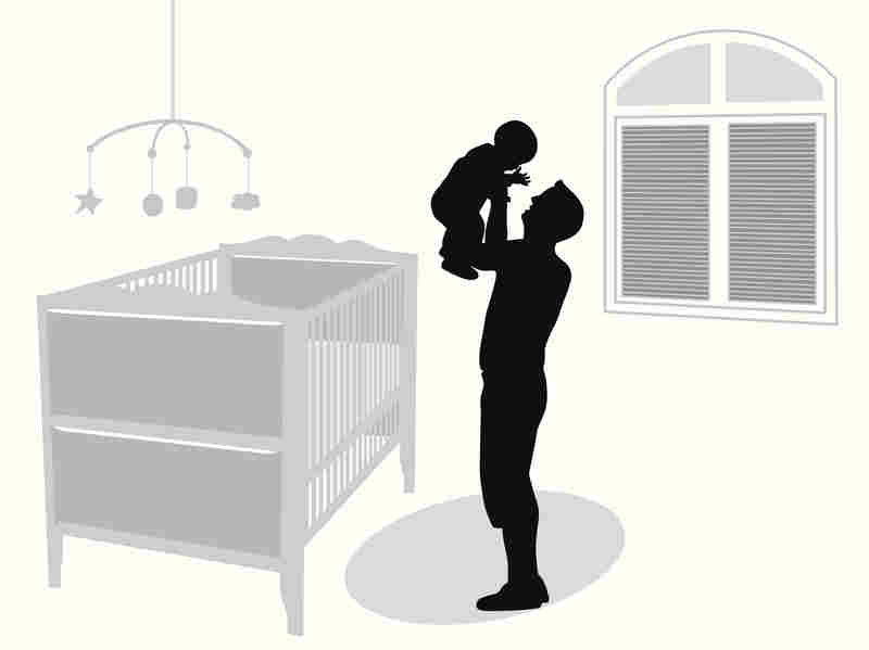 A father holds up his baby.